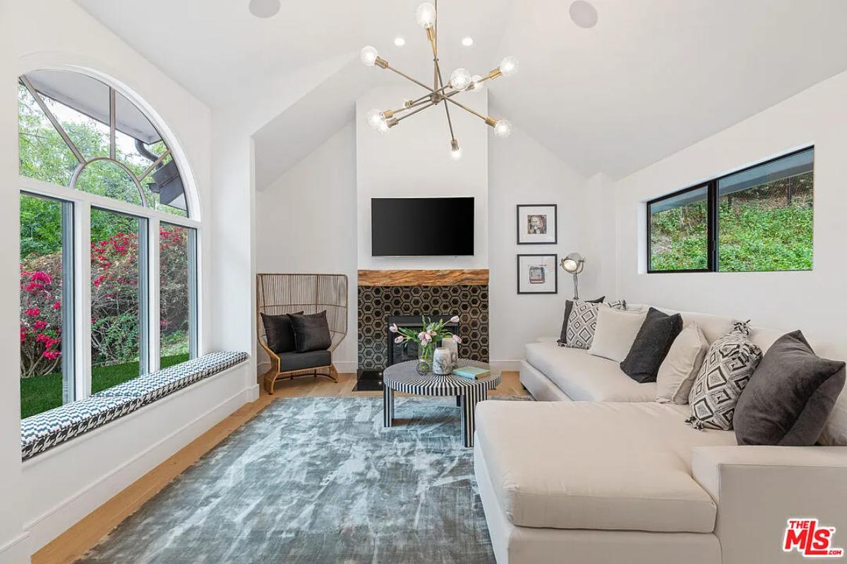 Family room with couches and a fireplace.