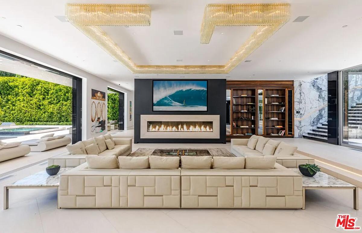 Living room with couches and a fireplace.