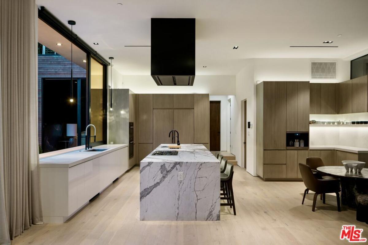 Kitchen with custom cabinetry and a counter breakfast bar.