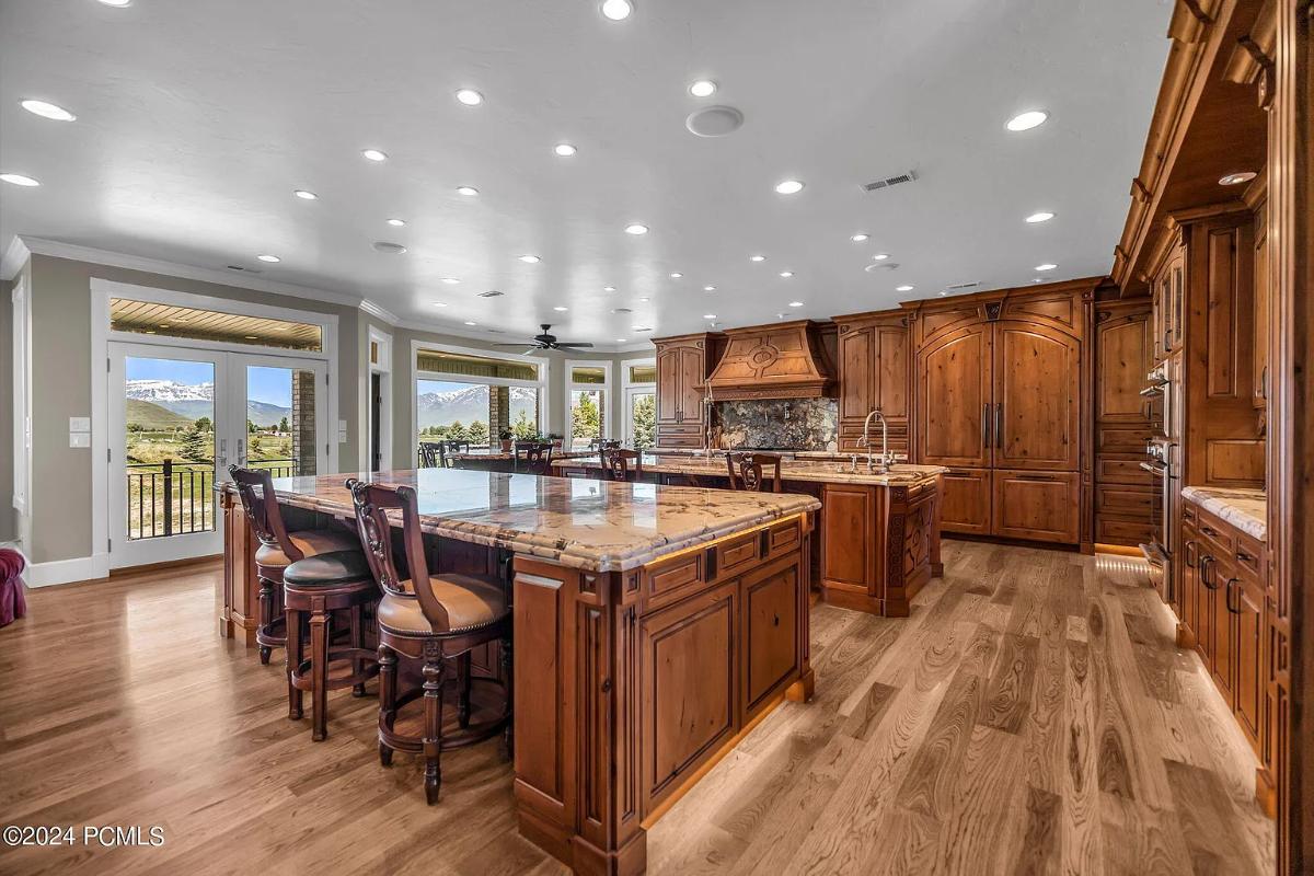 Kitchen with custom cabinetry, a counter breakfast bar and a center island prep area.