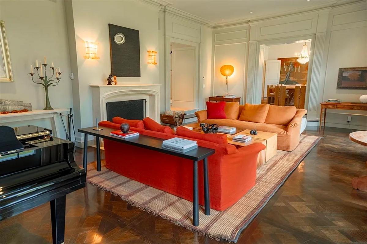 Living room with couches and a fireplace.