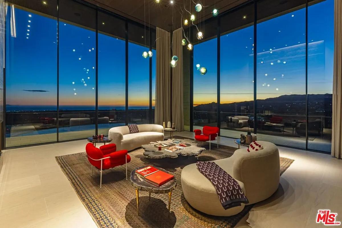 Living room with glass walls and high ceilings.