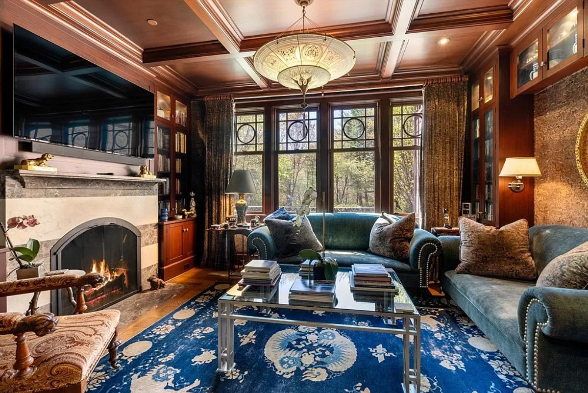 Living room with couches and a fireplace.