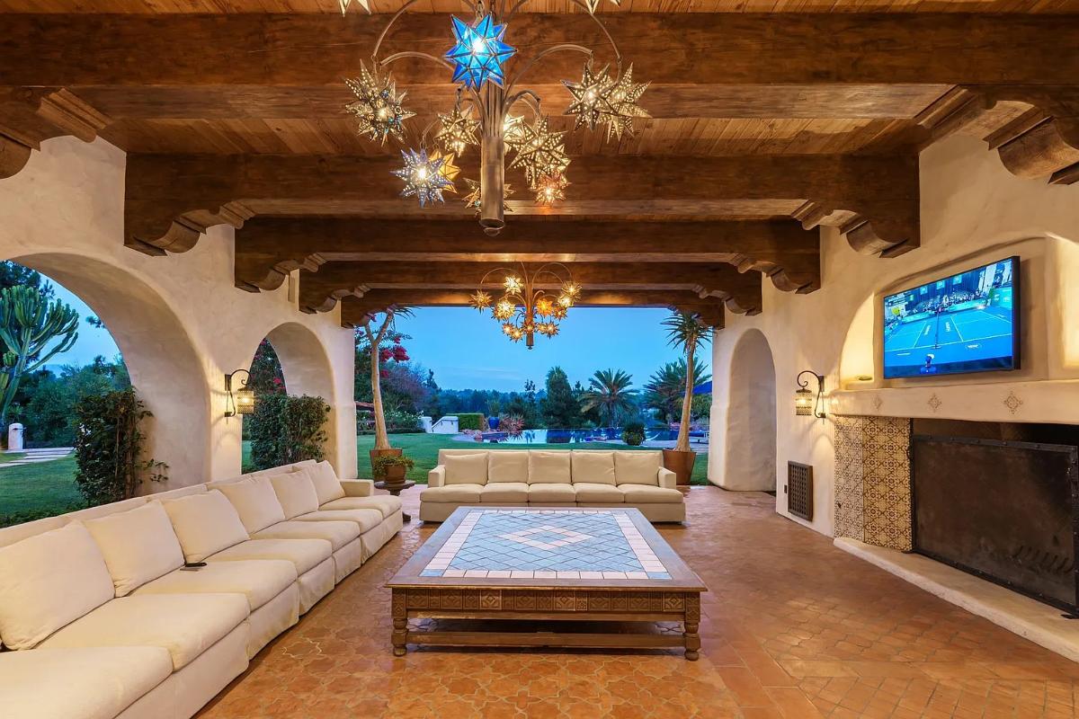 Outdoor living space with a fireplace.