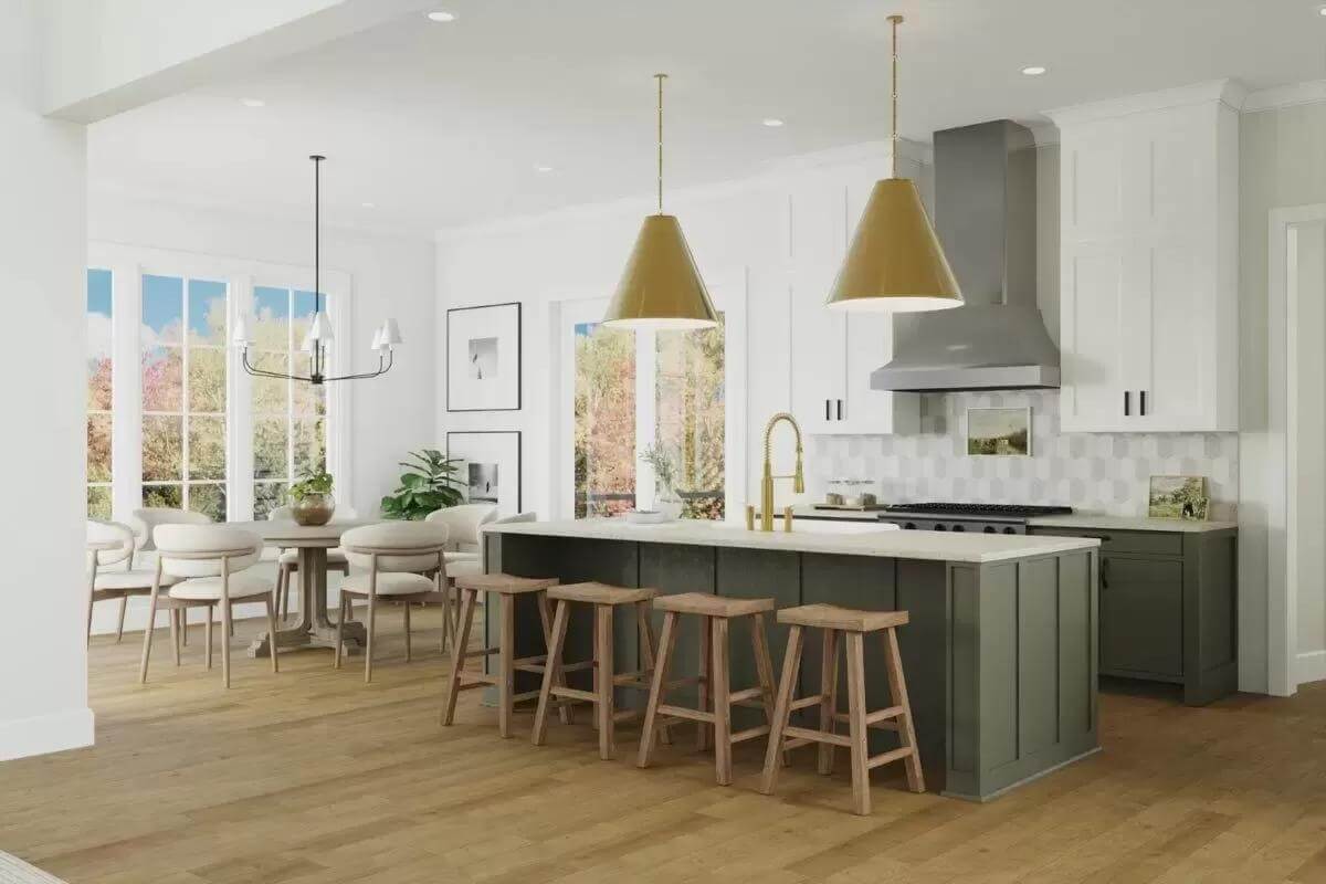 Kitchen and dining area illuminated brass pendants, recessed ceiling lights, and white-framed windows.