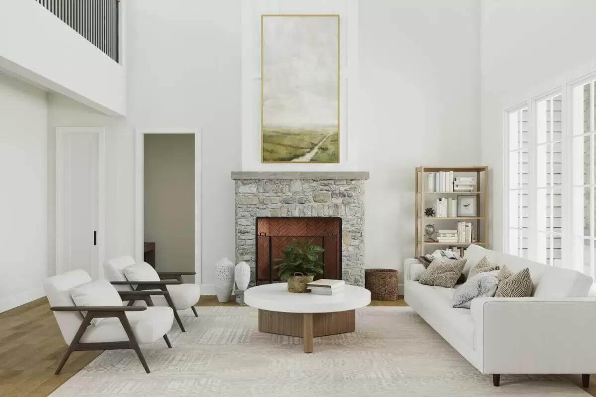 Living room with modern seats, a round coffee table, and a stone fireplace.