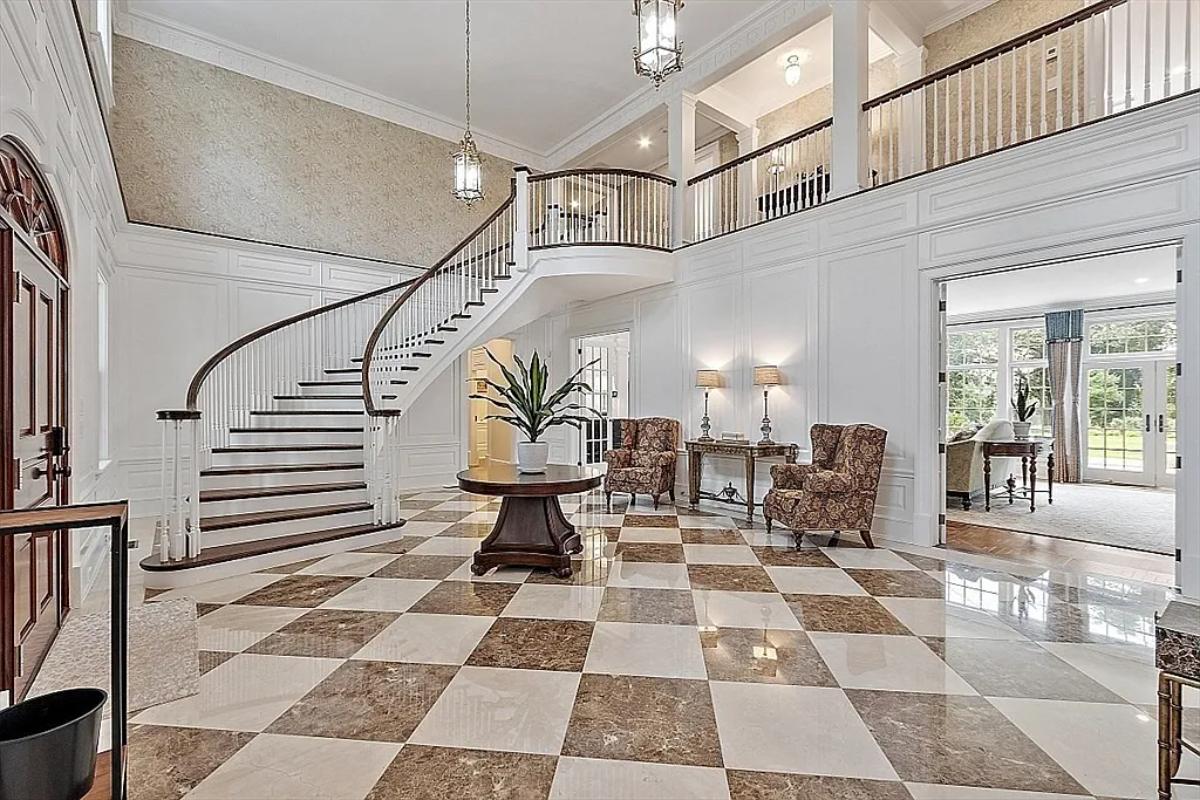 Foyer with high ceilings and stairs.