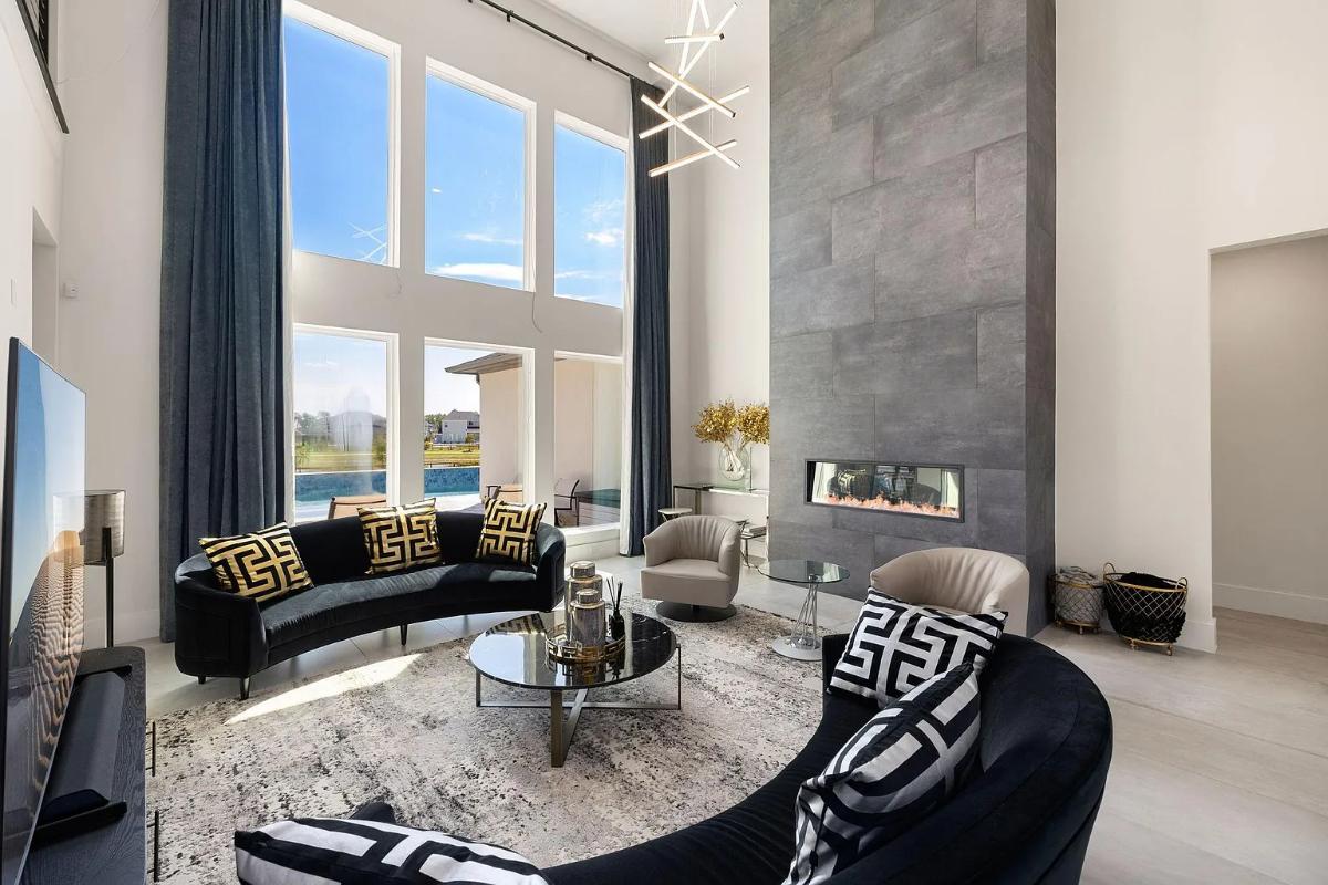 Living room with high ceilings and a fireplace.