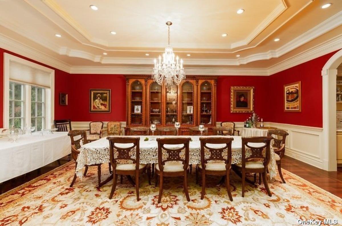 Dining room with a chandelier and carpet flooring.
