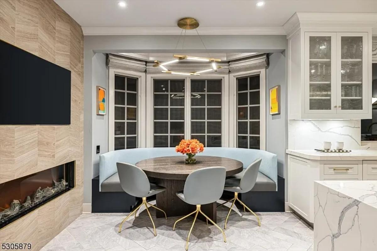Breakfast nook with a TV and a fireplace.