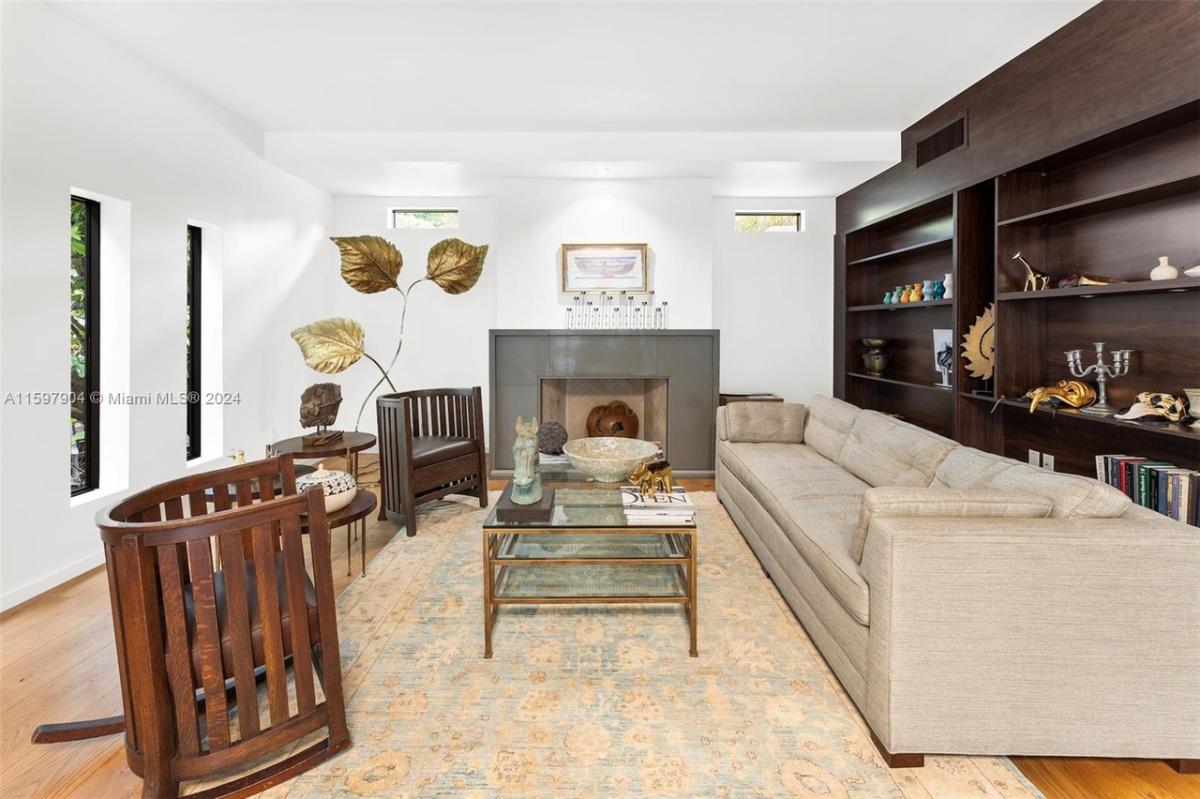 Living room with couches and a fireplace.