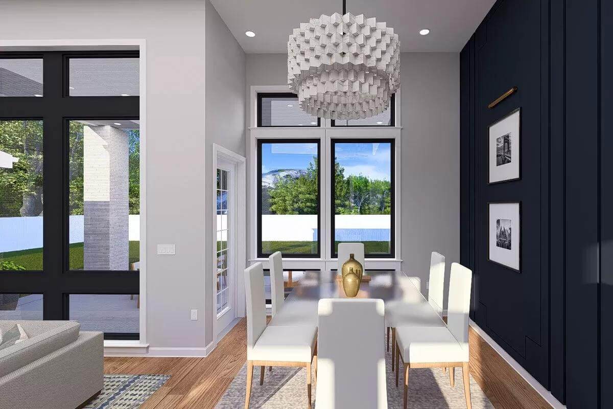 Dining area with a glass-top dining set illuminated by an oversized pendant light.