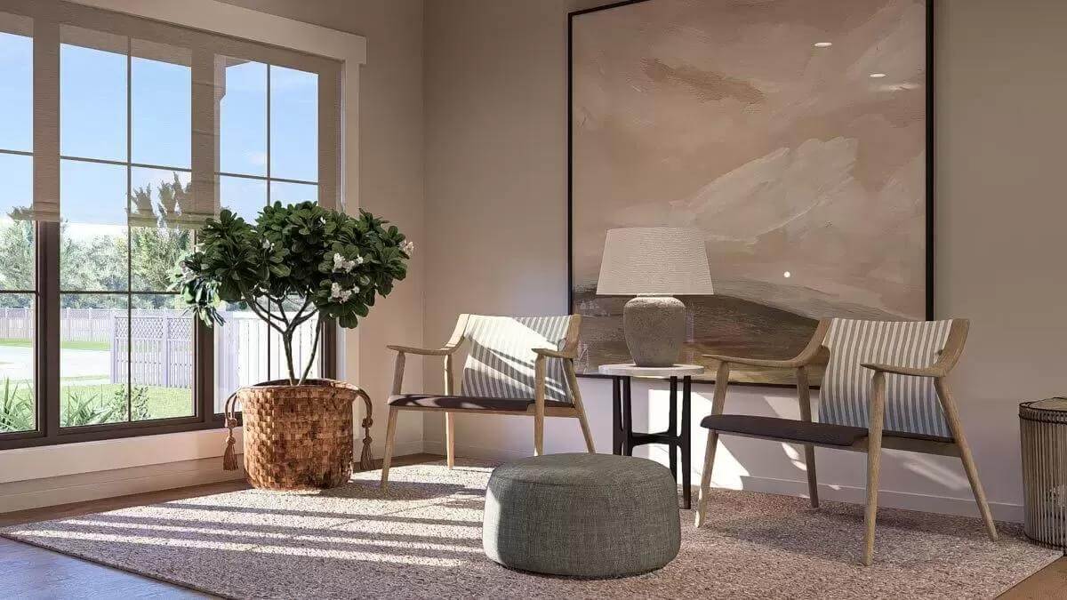 Sitting room with striped chairs and a round ottoman over the area rug.