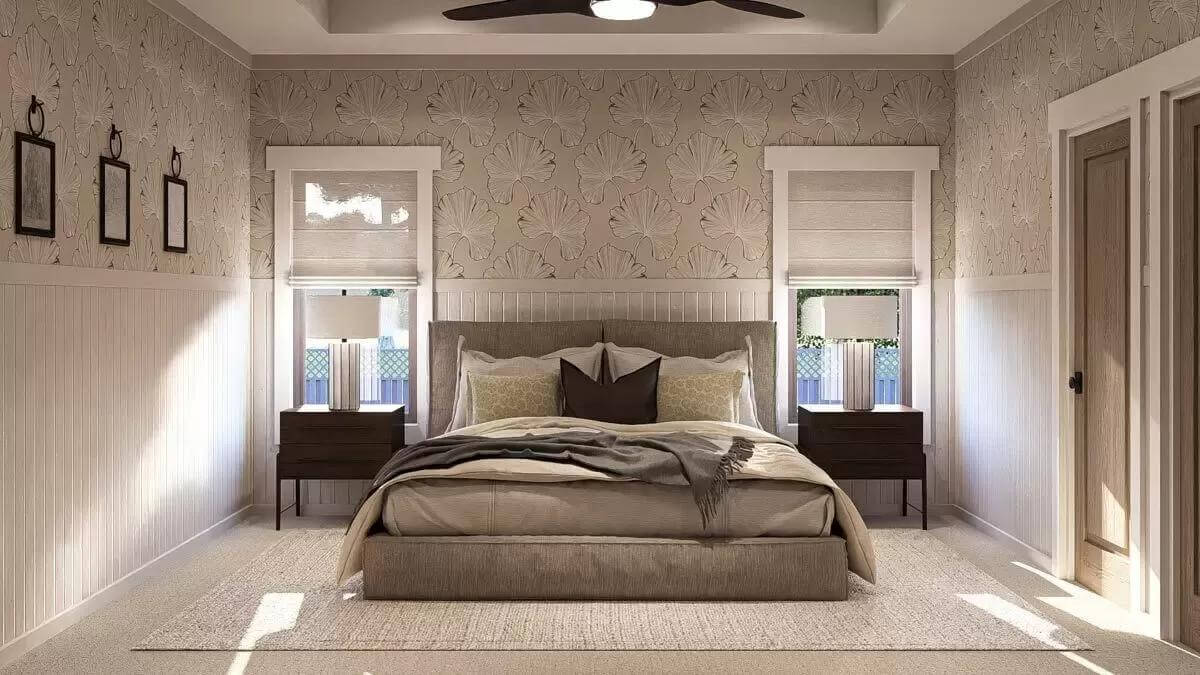 Primary bedroom with an upholstered bed flanked by dark wood nightstands.