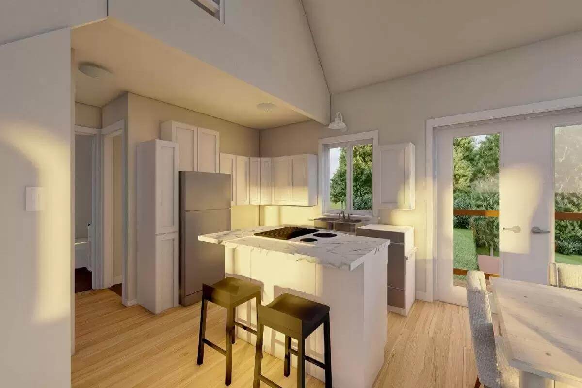 Kitchen with white cabinets, slate appliances, and a cooktop island.