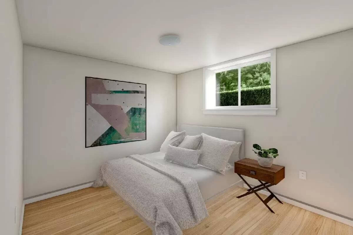 Primary bedroom with an upholstered bed topped by a white-framed window.