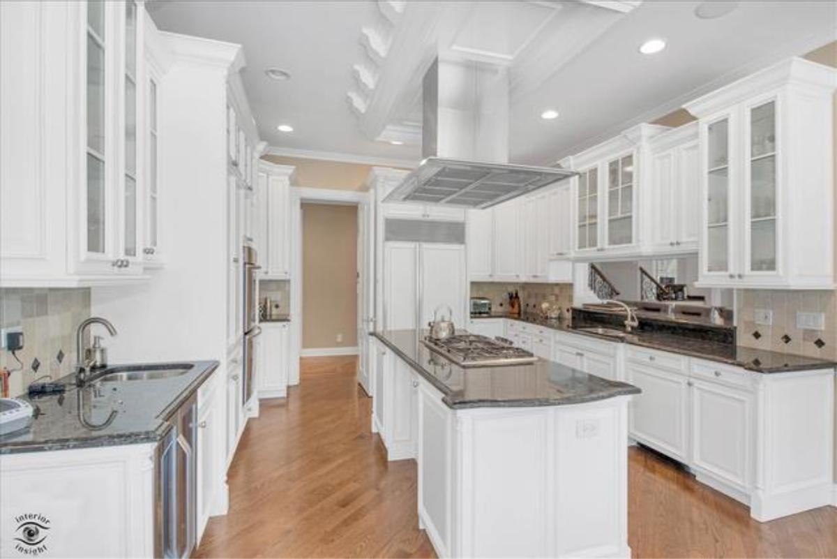 Kitchen with custom cabinetry and a center island prep area.