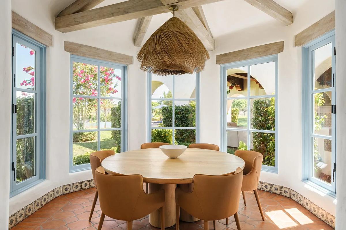 Breakfast nook with a round wood table.