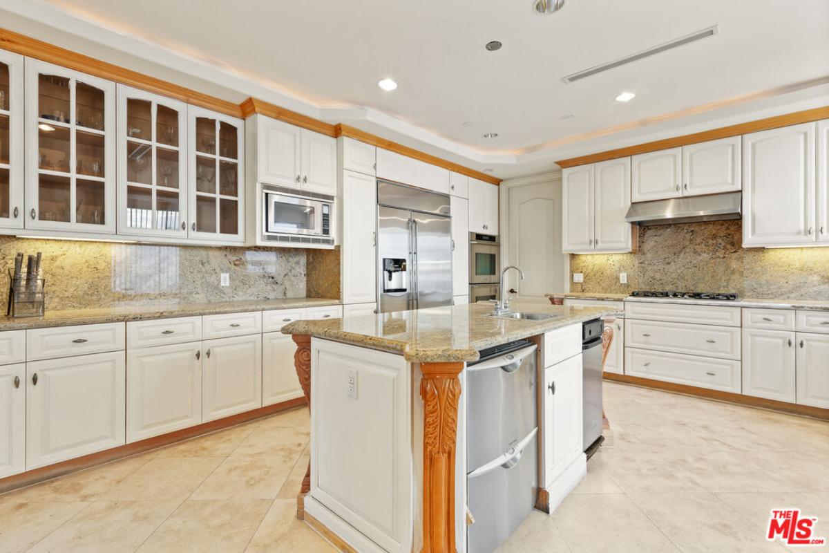 Kitchen with stainless-steel appliances and a center island prep area.