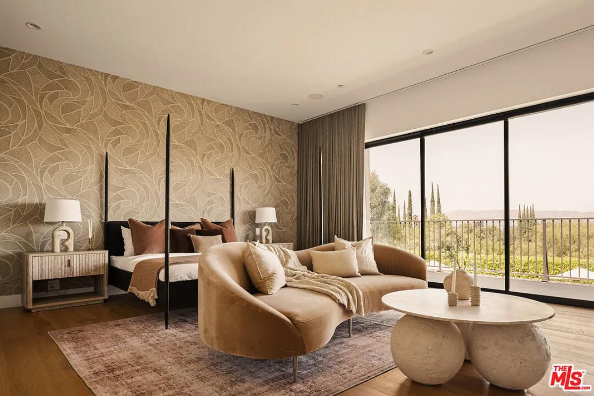 Bedroom with a large bed, glass walls and hardwood floors.