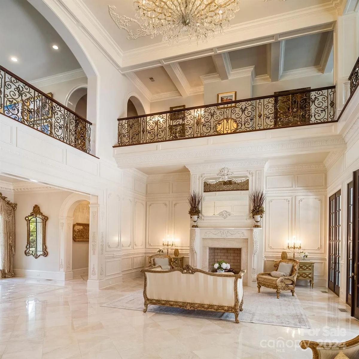 Living room with high ceilings and a fireplace.