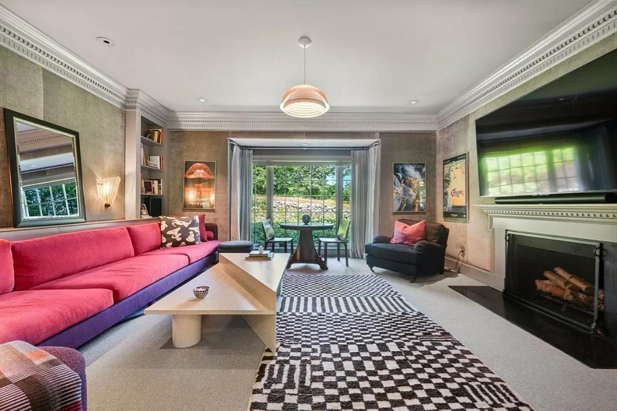 Living room with couches and a fireplace.