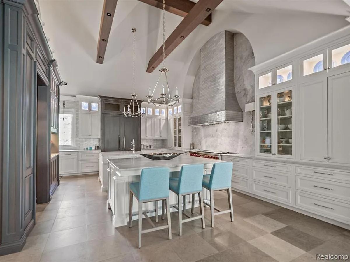 Kitchen with custom cabinetry, a counter breakfast bar and a center island prep area.