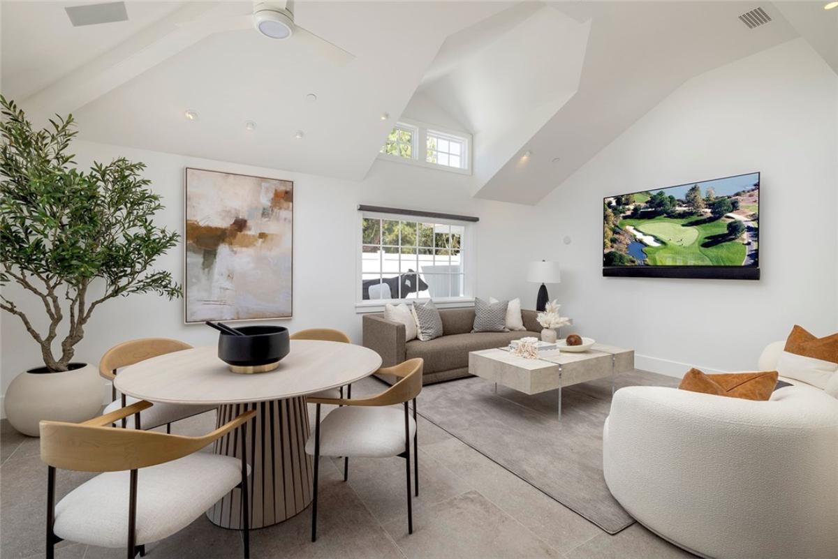 Family room with couches, TV and a dining area.