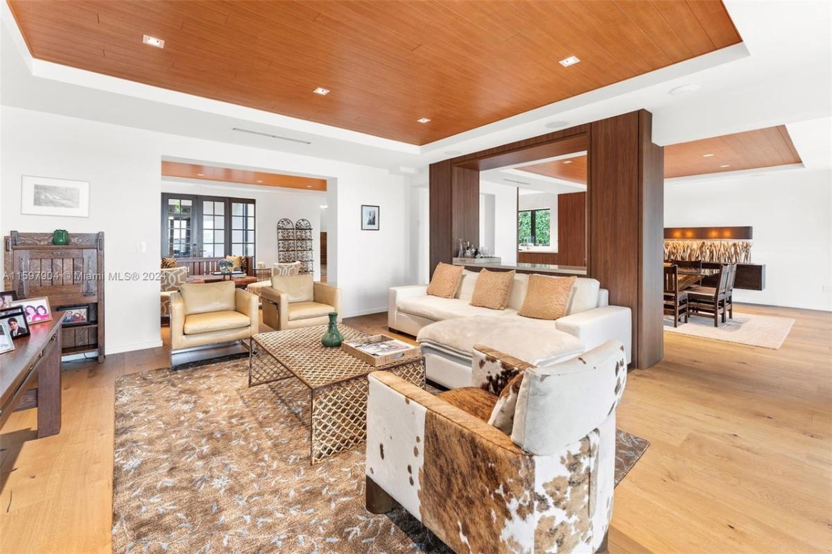 Living room with couches and custom lighting.