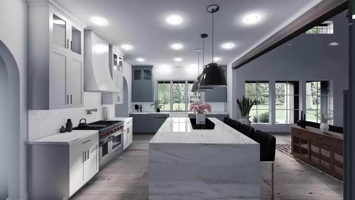 Kitchen with white cabinets and a waterfall island topped by dome pendants.