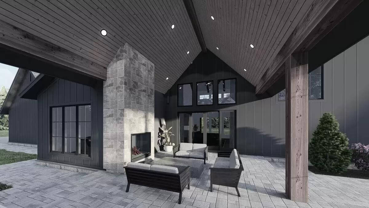 Outdoor living with wicker sofas and a stone fireplace.