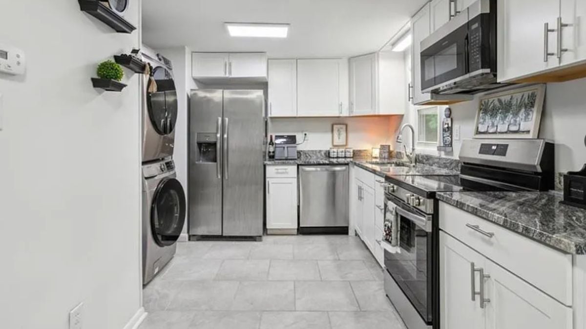 A kitchen with a countertop, cabinets, a sink, and kitchen appliances.