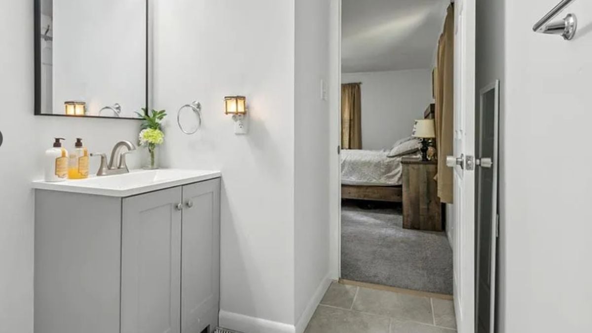 A bathroom with a vanity and a mirror.