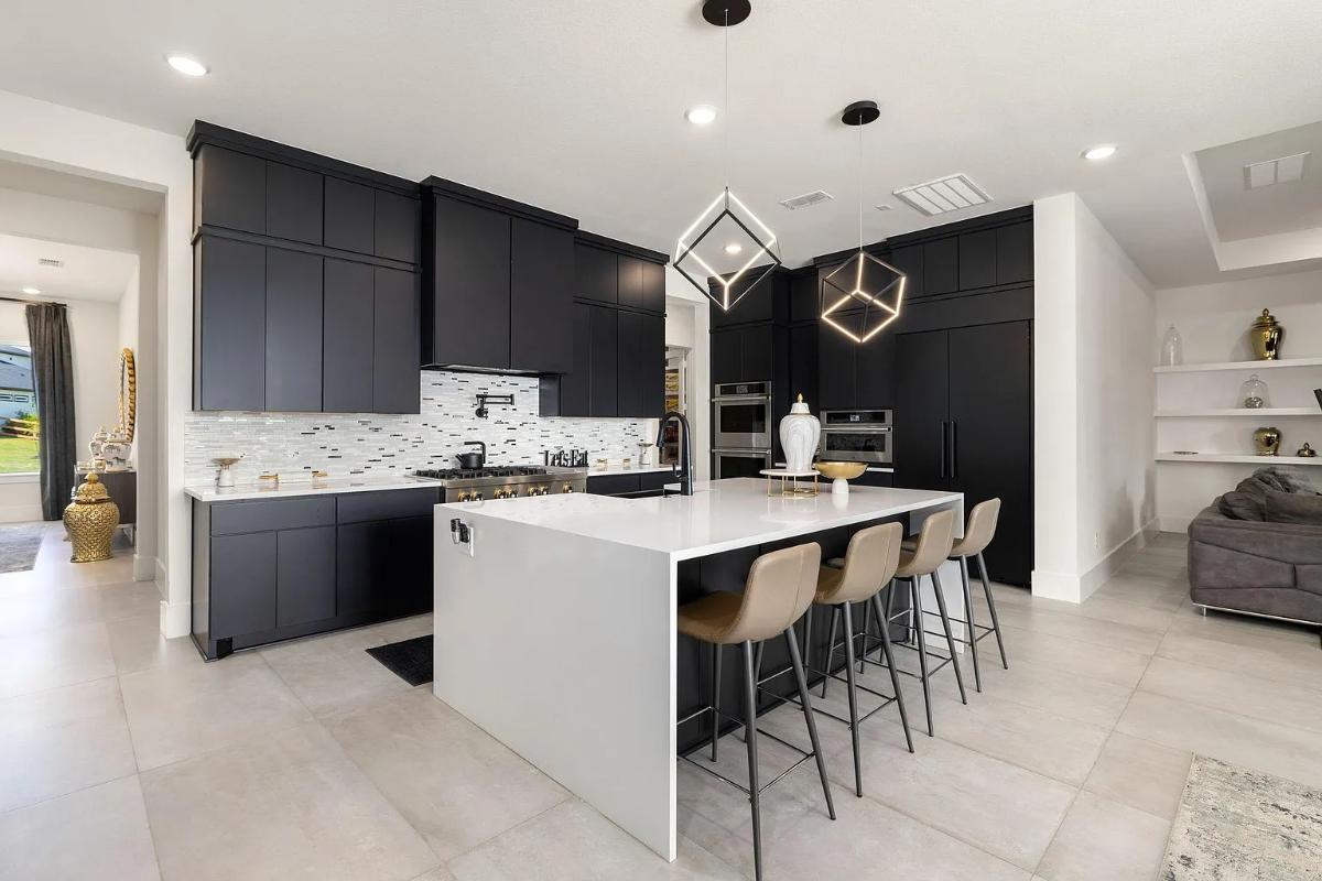 Kitchen with custom cabinetry, a counter breakfast bar and stainless-steel appliances.