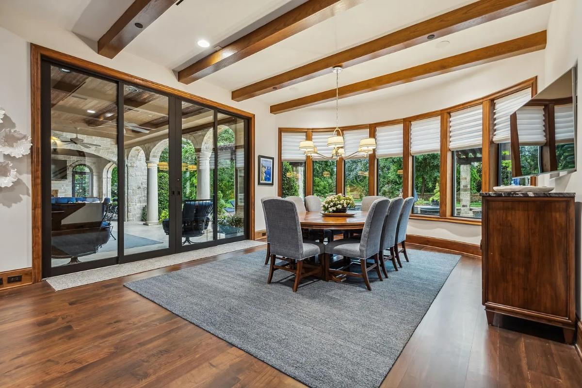 Breakfast nook with a round wood table.
