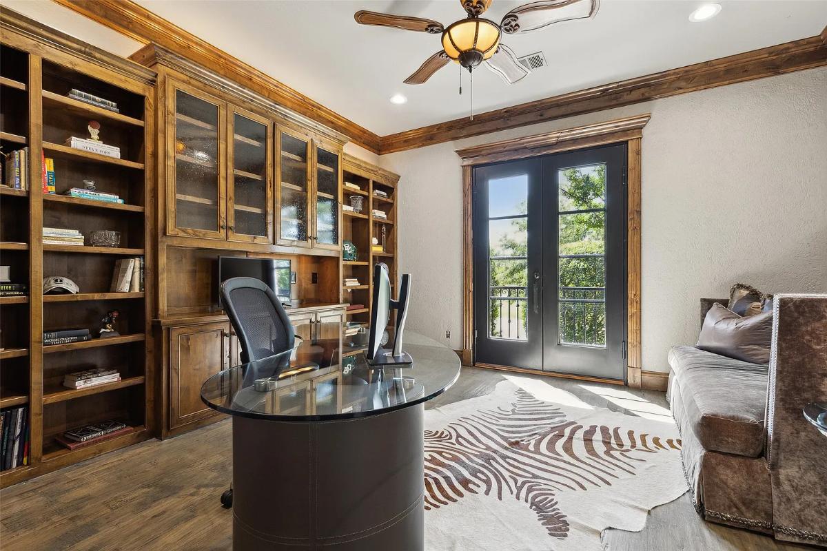 Home office with hardwood floors and a couch.