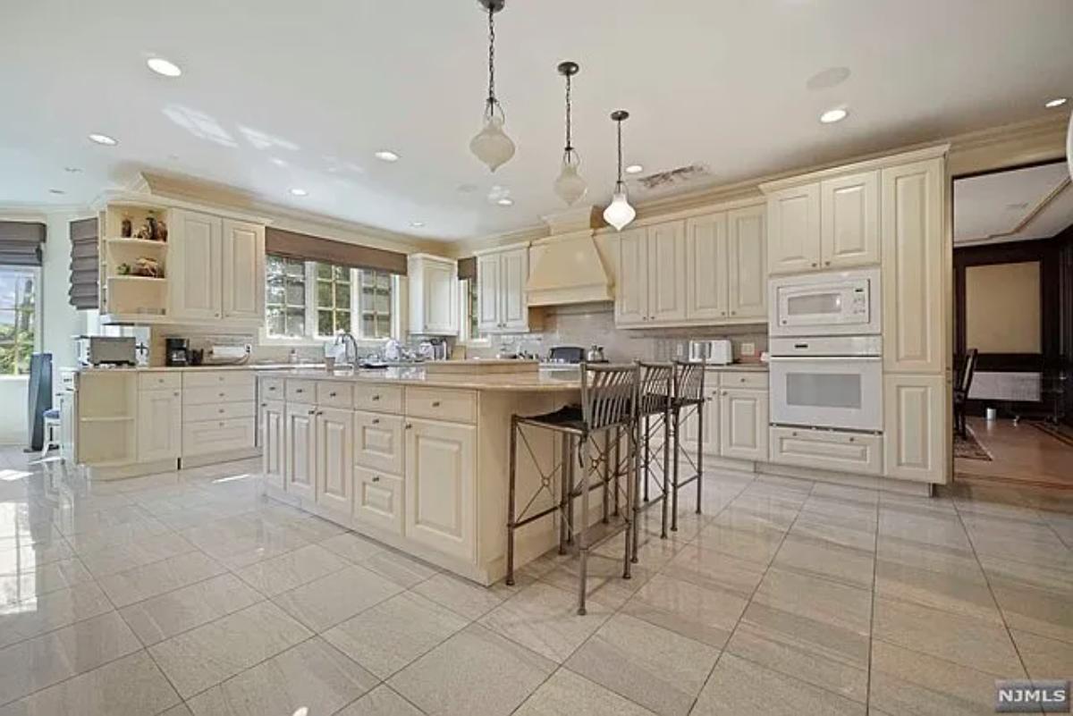 Kitchen with custom cabinetry and a counter breakfast bar.