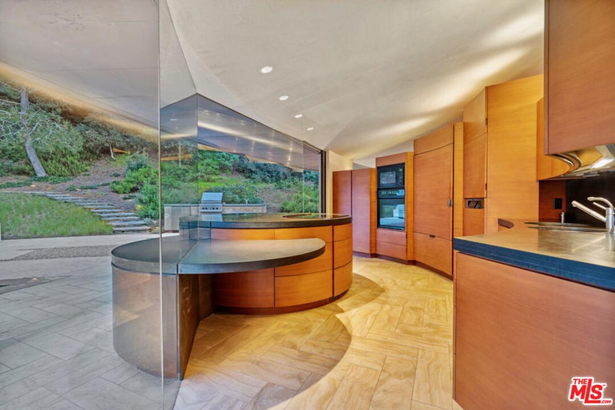 Kitchen with custom cabinetry and glass walls.