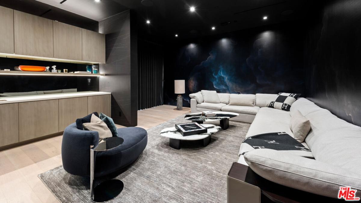 Living room with couches and custom lighting.