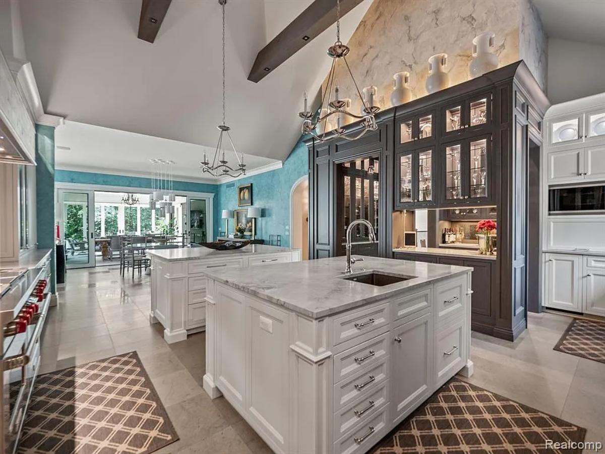 Kitchen with custom cabinetry, a counter breakfast bar and a center island prep area.
