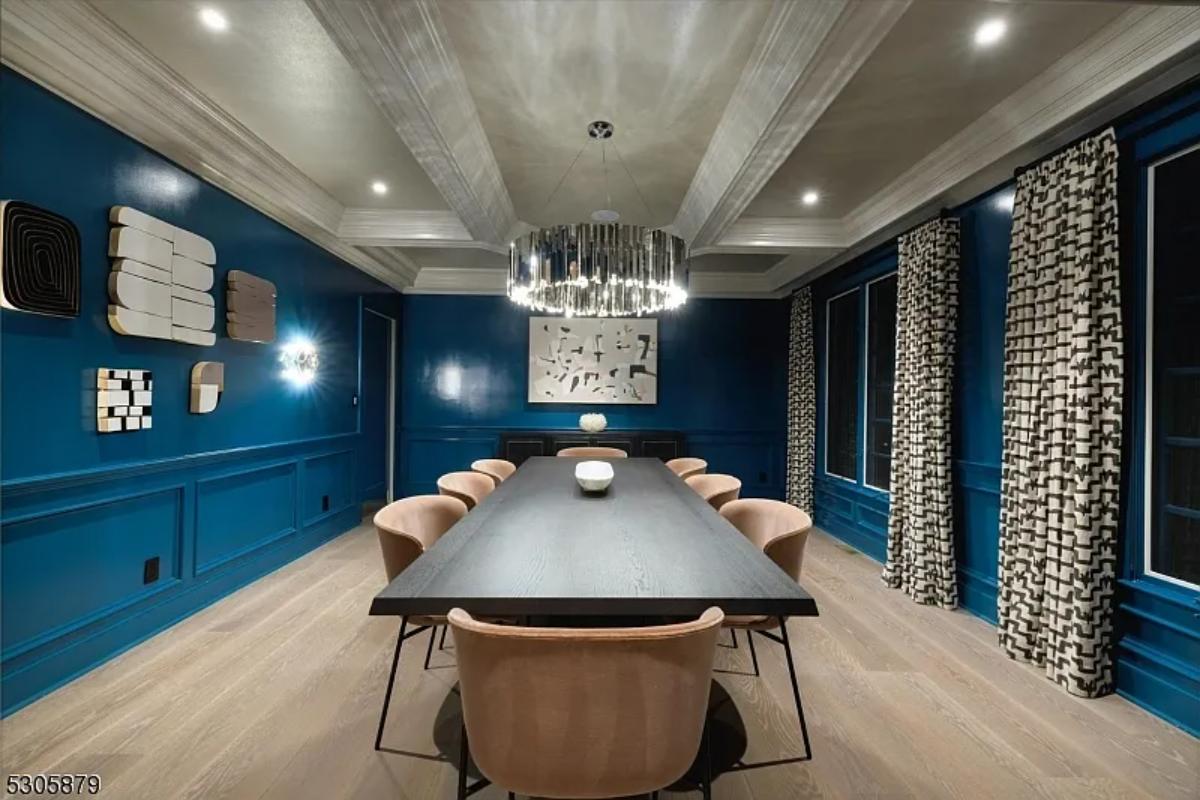 Dining room with hardwood floors and a chandelier.