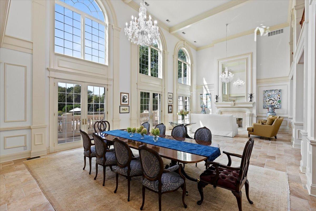 Dining room with high ceilings and a chandelier.