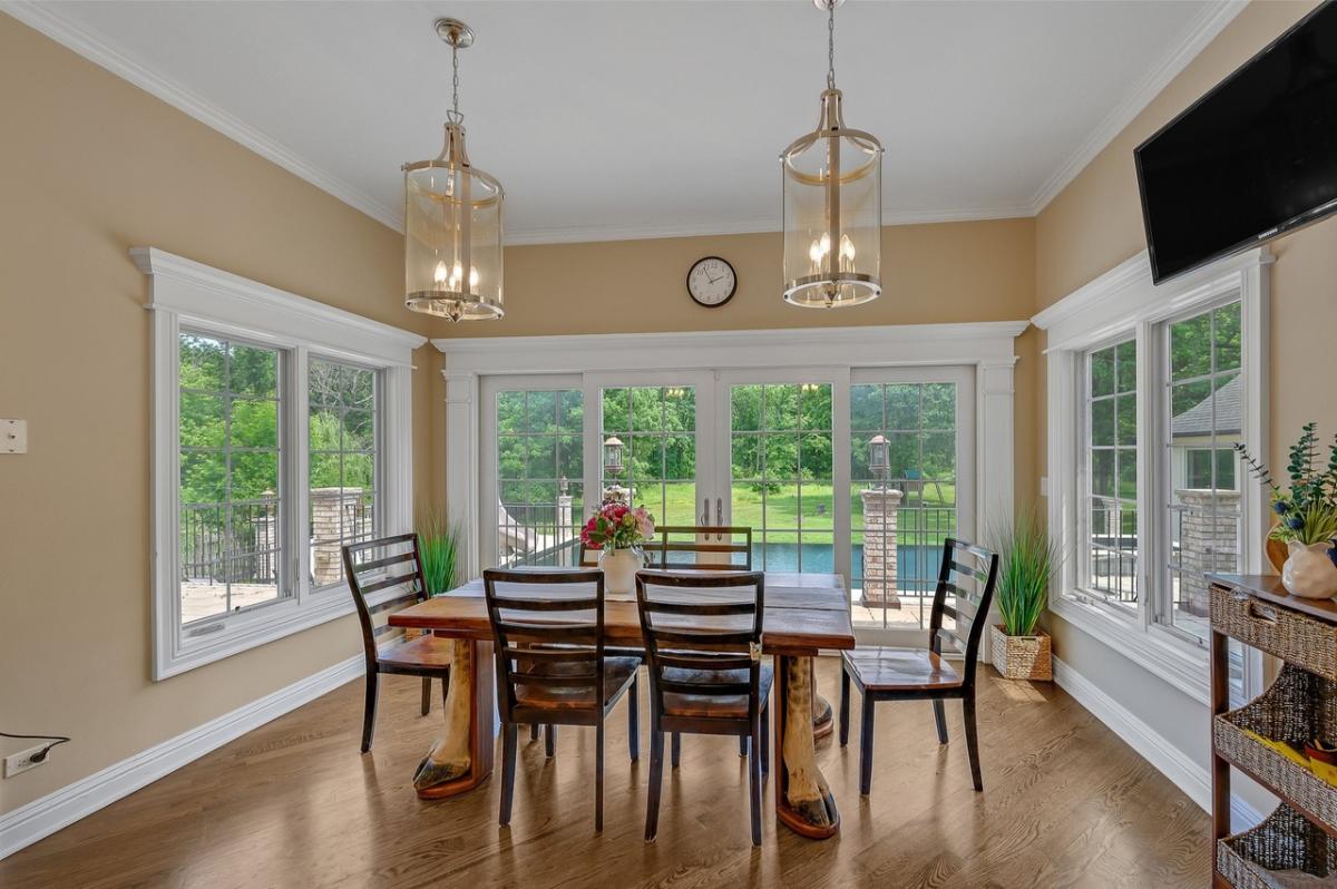 Dining room with hardwood floors and glass doors.