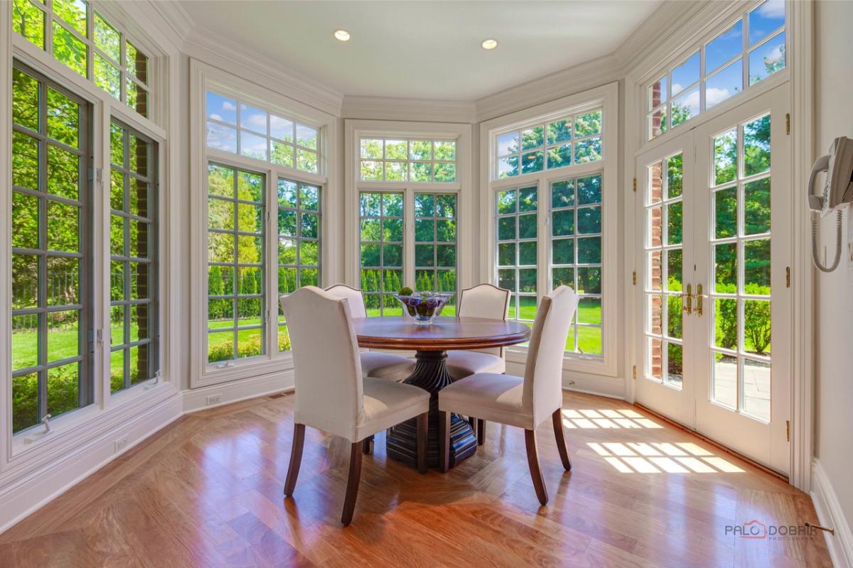 Breakfast nook with a round wood table.