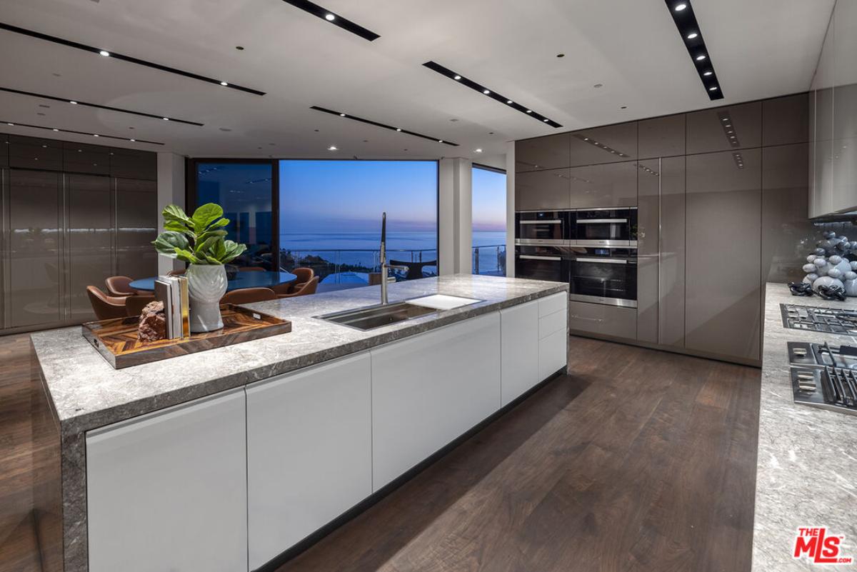 Kitchen with custom cabinetry and an island prep area.