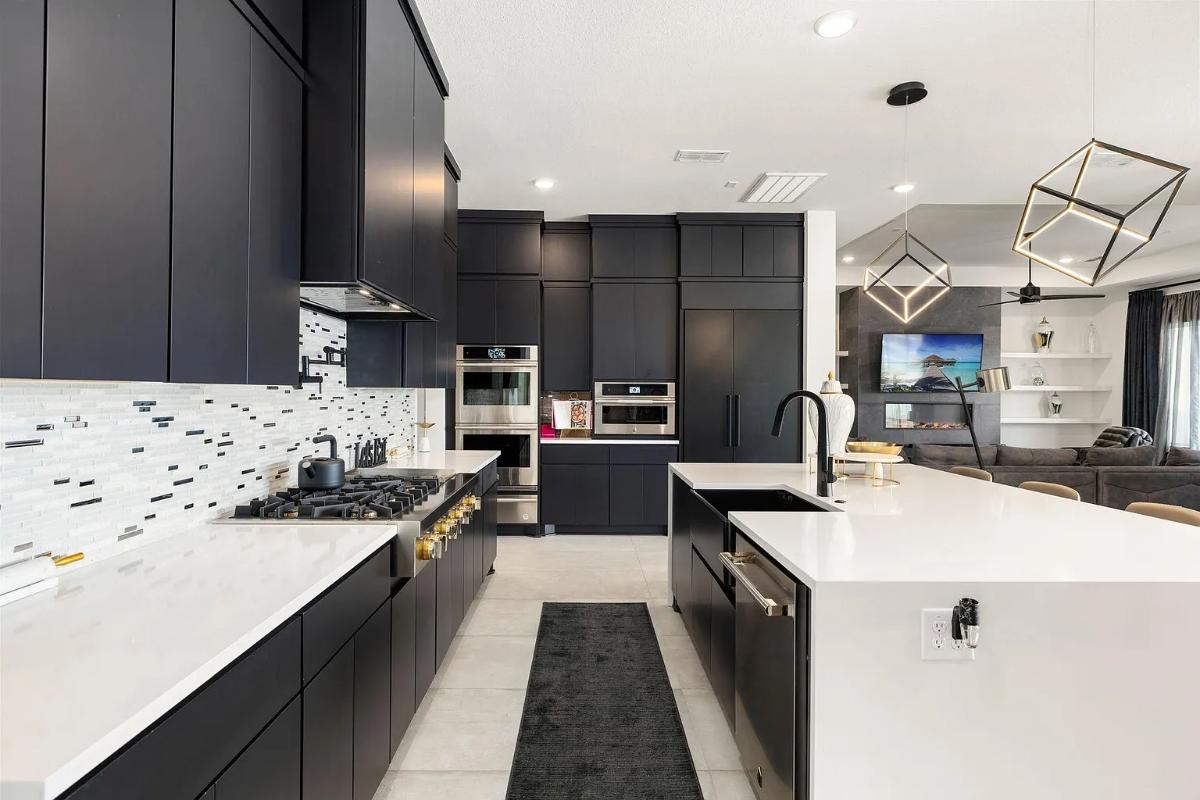 Kitchen with custom cabinetry, a counter breakfast bar and stainless-steel appliances.