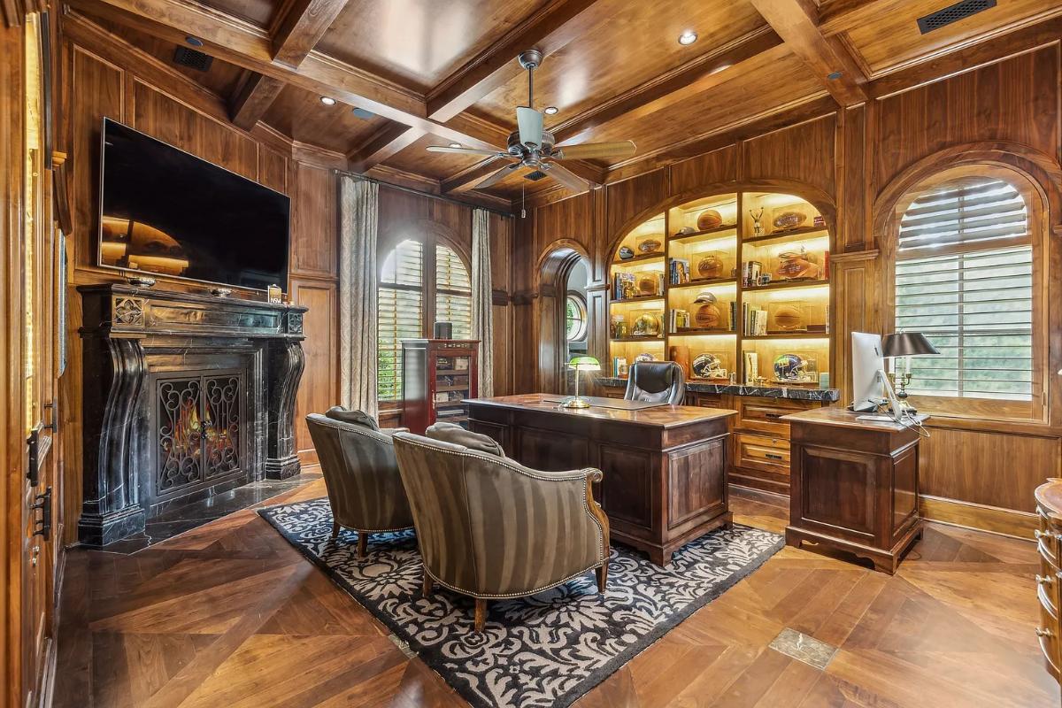 Home office with coffered ceilings and a fireplace.