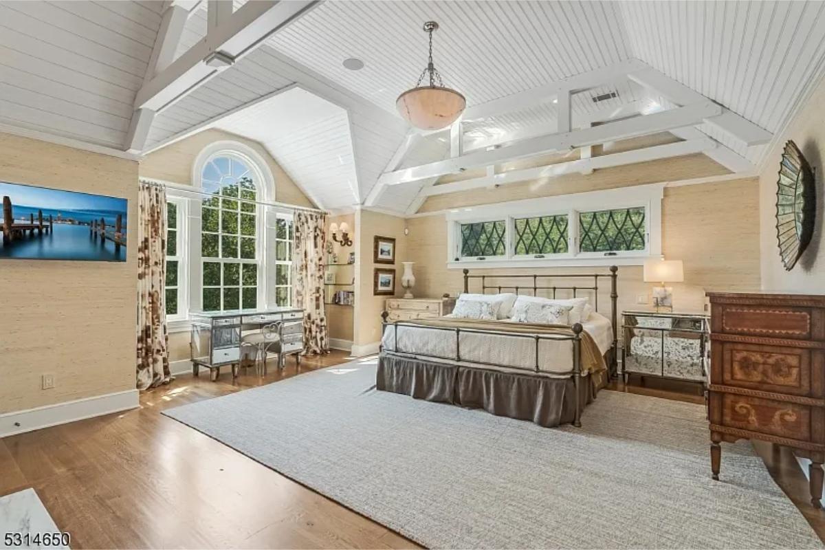 Bedroom with a large bed and hardwood floors.