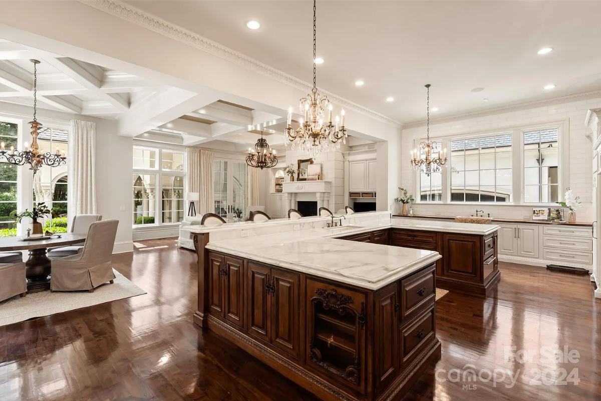 Kitchen with a counter breakfast bar and chandeliers.