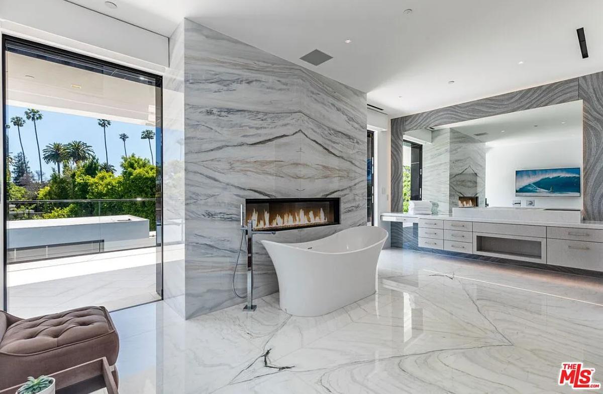 Bathroom with a soaking tub and a fireplace.